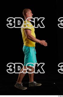 Walking reference of yellow shirt turquoise shorts brown shoes Leland…